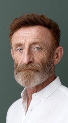 Obraz premium A close-up studio portrait of a mature man with red hair and a distinguished beard.