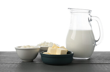 Different dairy products on grey wooden table against white background