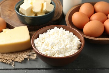 Different dairy products and eggs on grey wooden table, closeup