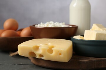 Different dairy products and eggs on grey wooden table, closeup