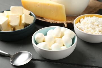 Different dairy products on grey wooden table, closeup