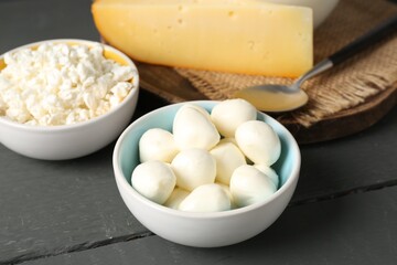 Different dairy products on grey wooden table, closeup