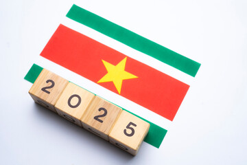 2025, Suriname flag with date block, Concept, Important events for Suriname the new year, election, economy, social activities, central bank, Suriname foreign policy