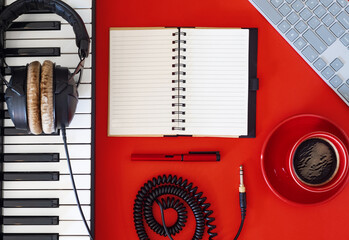 Inspiration for songwriting. Music tools and coffee on red background.