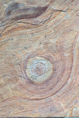 Weathered rock with ochre pigment tones. Grunge surface for artistic projects