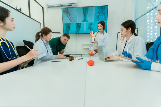 Medical team working on digital tablet technology for medical use using computers to analyze, collaborate and brainstorm in clinic. Healthcare meeting concept.