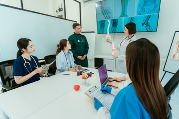 Medical team working on digital tablet technology for medical use using computers to analyze,...