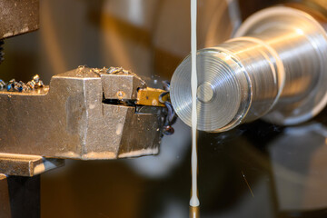 The lathe machine finish cut metal shaft parts with liquid coolant method.