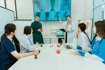 Medical team working on digital tablet technology for medical use using computers to analyze,...
