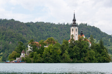 A serene view of the iconic Pilgrimage Church of the Assumption of Mary situated on Bled Island,...