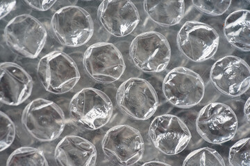 Close-up of blue bubble wrap texture. Air-filled plastic used for packaging, protection, and stress relief. Ideal abstract background for design, delivery, business, or environmental concepts.