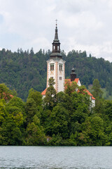 A serene view of the iconic Pilgrimage Church of the Assumption of Mary situated on Bled Island,...
