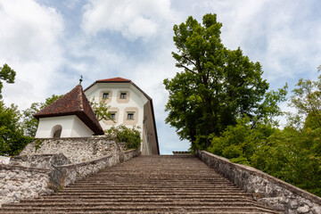 A low-angle view captures the famous stone staircase leading up to the Church of the Assumption of...