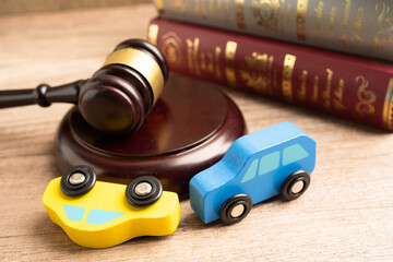 Car accident lawsuit and insurance, Judge hammer with car model.