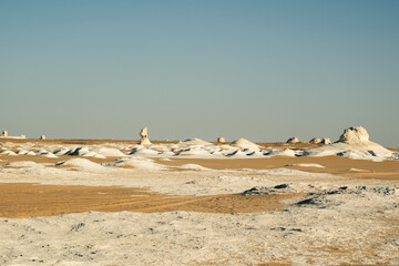 White rock formations and sand dunes in Egypt's White Desert, natural desert landscape	
