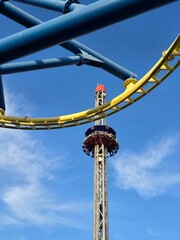 Thrilling Drop Tower Ride Framed by Roller Coaster Structure