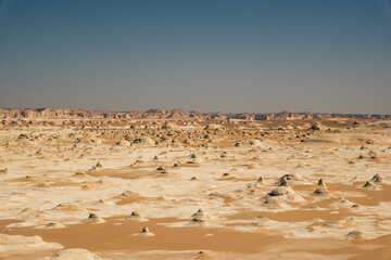 White rock formations and sand dunes in Egypt's White Desert, natural desert landscape	
