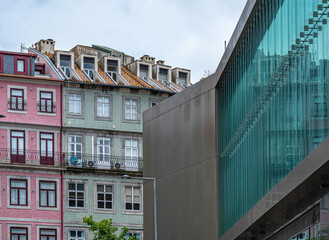Traditional architecture against a modern glass fronted building in Porto, Portugal.