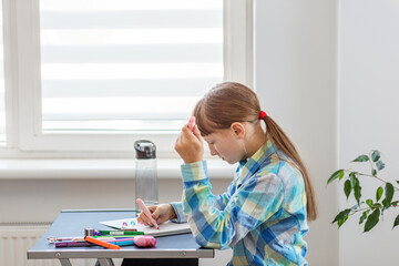 Young girl concentrating on drawing project