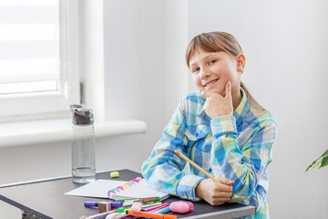 Playful girl posing during study time.