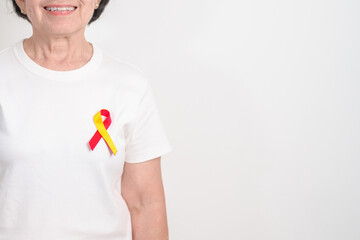 World hepatitis day awareness month, 28 July. elderly woman with Red and Yellow ribbon. Liver...