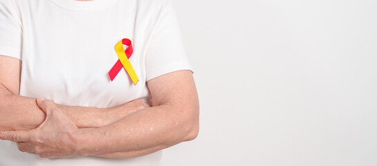 World hepatitis day awareness month, 28 July. elderly woman with Red and Yellow ribbon. Liver...