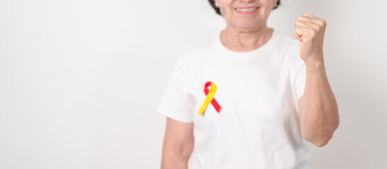 World hepatitis day awareness month, 28 July. elderly woman with Red and Yellow ribbon. Liver...
