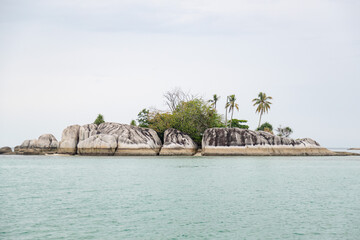 granite island with coconut trees