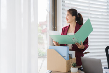 New Start: A serene portrait captures a poised woman gazing out a window, office, and a new chapter...