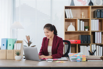 Elegant Executive at Work: A sophisticated executive, seated at a modern desk, immersed in her work...