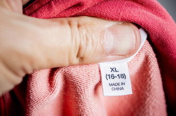 Detailed close-up of a clothing tag labeled 