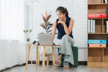 The Modern Worker's Corner: An elegant woman with focused gaze, engrossed in her work on a sleek...