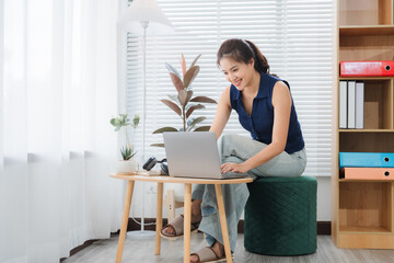 Modern Freelancer at Work: A professional woman exudes focus and engagement as she works remotely...
