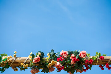 roses on wooden over blue sky.