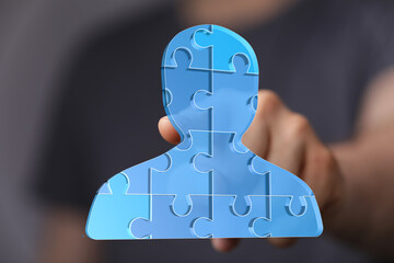 Abstract image of a person made of puzzle pieces, symbolizing teamwork and collaboration.