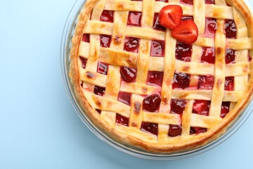 Tasty strawberry pie on light blue background, top view