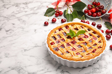 Tasty cherry pie and berries on white marble table, closeup. Space for text