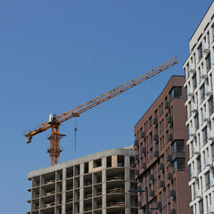 An occupied building, a newly constructed building, and a building still under construction with a...