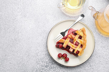 Piece of tasty cherry pie, berries and tea on grey textured table, flat lay. Space for text