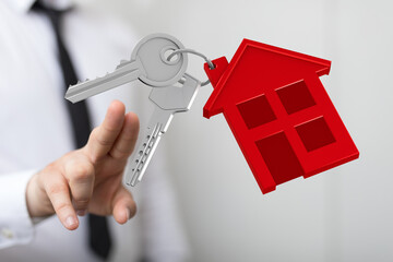 Image of house keys and a red house model, perfect for real estate, property, and homeownership...