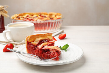 Piece of tasty strawberry pie and berries on white wooden table, closeup. Space for text