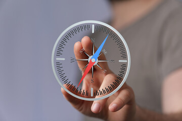 Hand interacting with a virtual compass, showing direction and guidance. Perfect for business,...