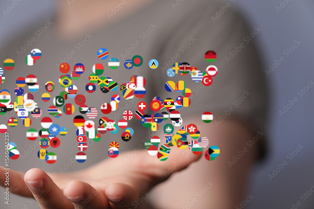 Poster image of many flags of the world swirling around a hand, representing global connections and interna