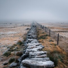Foggy landscape with a stone wall