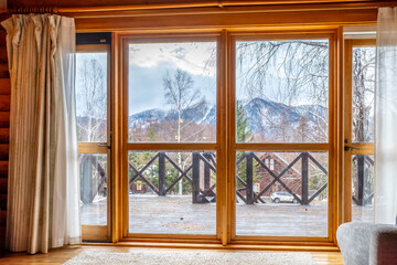 Moving white cloth curtains in winter morning with windows and door in cozy house