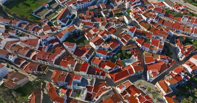 Aerial view of small village with windmill and picturesque rooftops, Odeceixe, Portugal