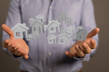 Image of a real estate agent showcasing virtual houses, symbolizing property management or sales.