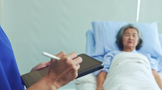 Female doctor checkup asks and records the symptoms female patient while she is being treated in a hospital bed in a friendly manner which makes the patient feel relaxed.
