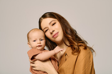 Beautiful young mother embraces her child in a warm and loving moment indoors