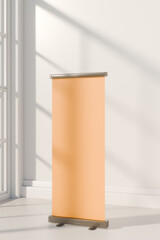 Portable orange rollup banner standing in bright, sunlit space near window. 3d rendering